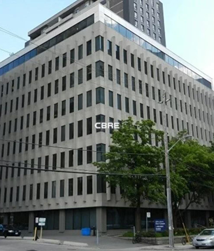 Exterior view of a multi-storey office building on a city street in Toronto.