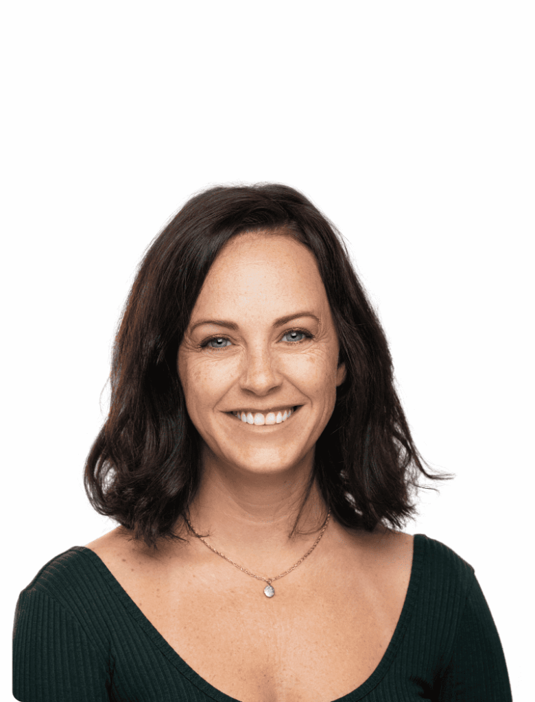 Smiling person with dark shoulder-length hair wearing a dark green top against a white background.